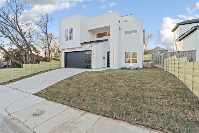 view of front of home featuring a garage and a front lawn