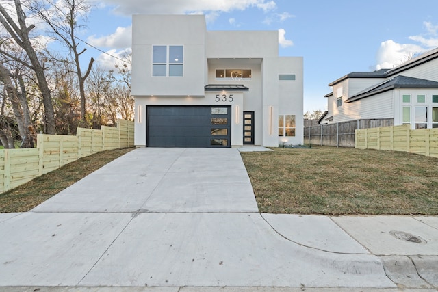 view of front facade with a garage and a front lawn