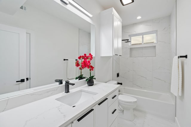 full bathroom with vanity, toilet, and tiled shower / bath