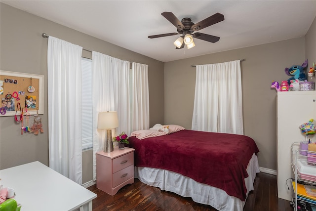 bedroom with ceiling fan and dark hardwood / wood-style flooring