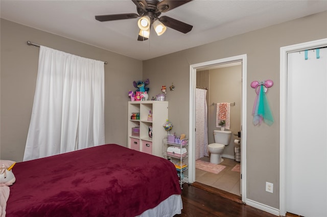 bedroom with dark hardwood / wood-style flooring, ensuite bath, and ceiling fan