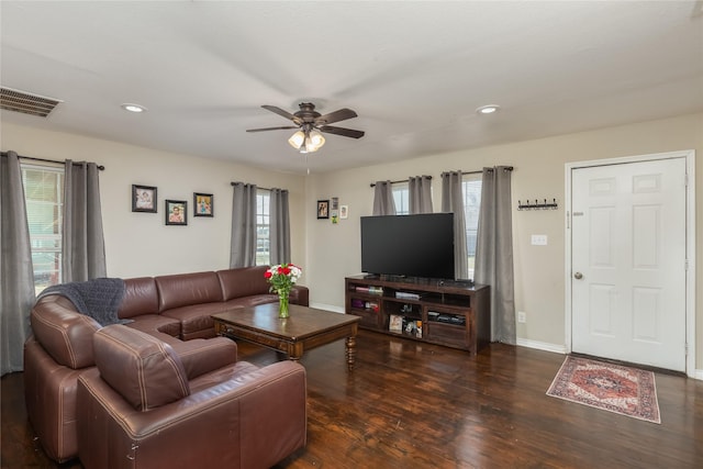 living room featuring ceiling fan and dark hardwood / wood-style flooring