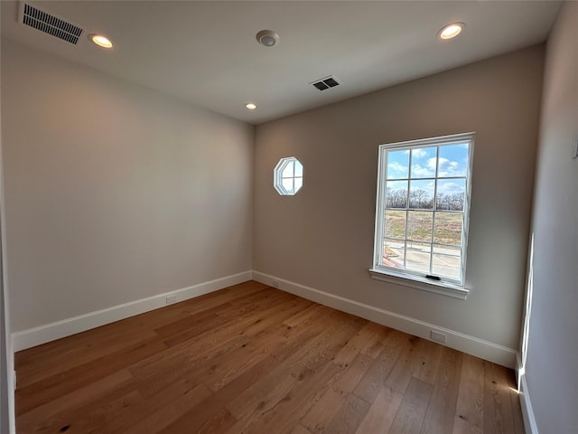 unfurnished room with light hardwood / wood-style floors