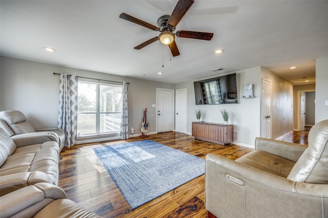 living room featuring ceiling fan and wood-type flooring