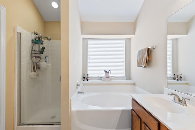 bathroom featuring vanity and shower with separate bathtub