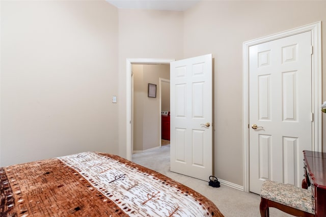bedroom featuring light carpet