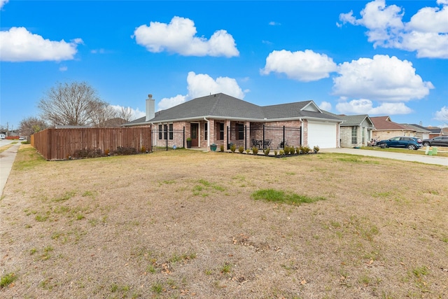 ranch-style home with a garage and a front yard
