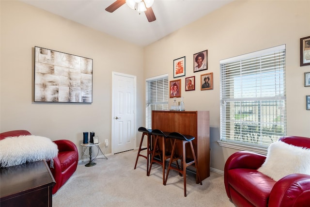 sitting room with ceiling fan and light colored carpet