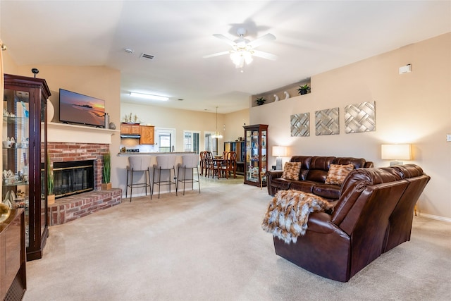 living room with light carpet, a brick fireplace, lofted ceiling, and ceiling fan