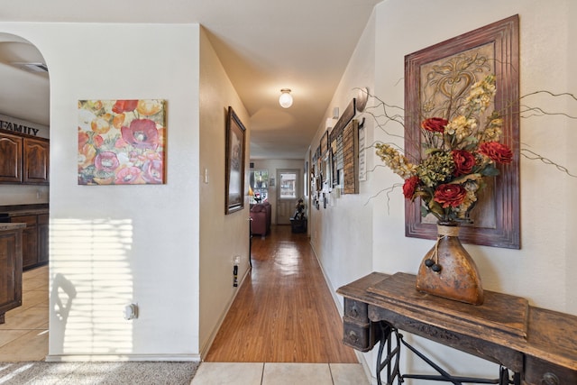 hall featuring light tile patterned floors