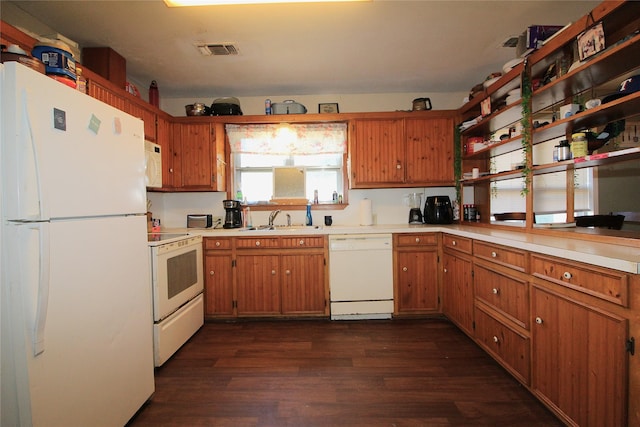 kitchen featuring light countertops, white appliances, dark wood-style flooring, and a sink