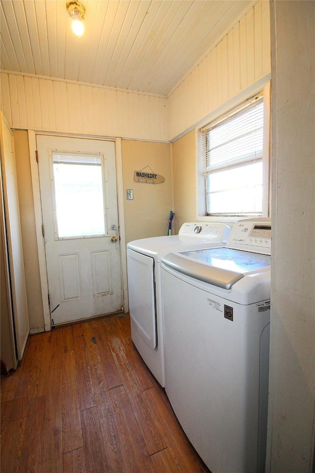 clothes washing area featuring laundry area, wooden ceiling, dark wood-style flooring, independent washer and dryer, and wood walls