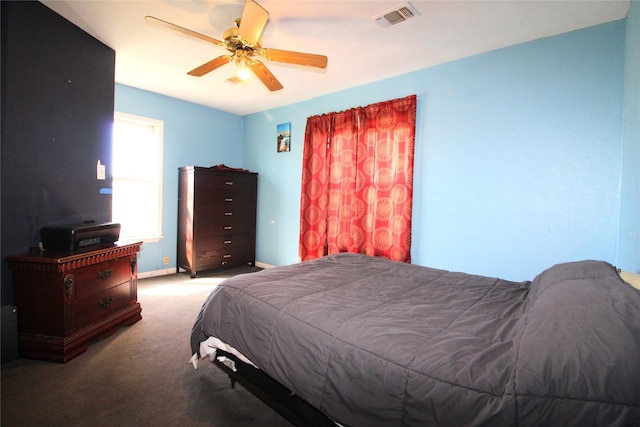 bedroom with light carpet, visible vents, and a ceiling fan