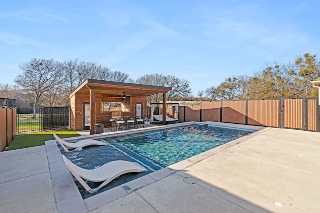 view of swimming pool featuring ceiling fan and a patio area