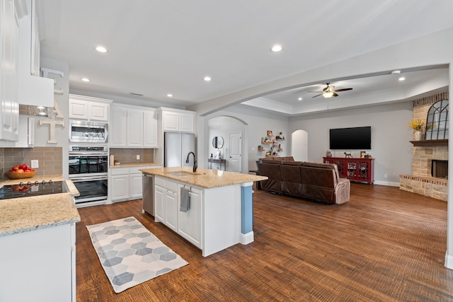 kitchen featuring white cabinetry, sink, a kitchen island with sink, and stainless steel appliances