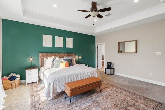 carpeted bedroom featuring crown molding, ceiling fan, and a raised ceiling