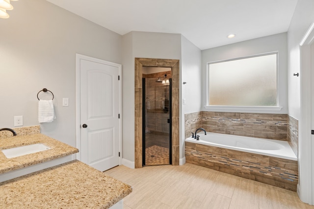 bathroom with vanity and plus walk in shower