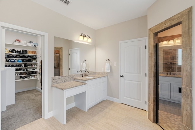 bathroom with an enclosed shower and vanity