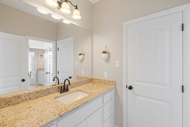 bathroom featuring vanity and a notable chandelier