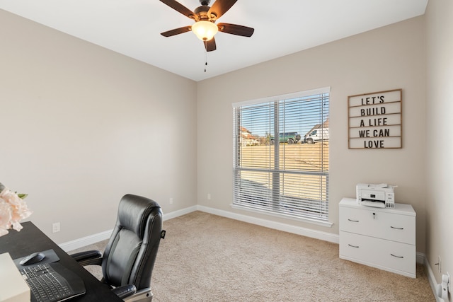 carpeted home office with ceiling fan