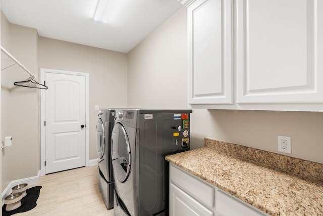 laundry room with cabinets and independent washer and dryer