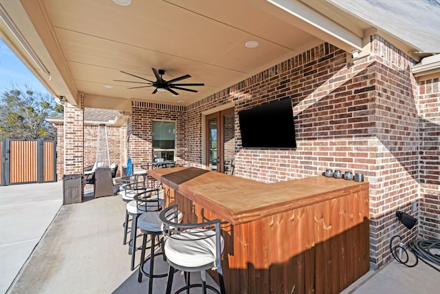 view of patio / terrace with exterior bar and ceiling fan