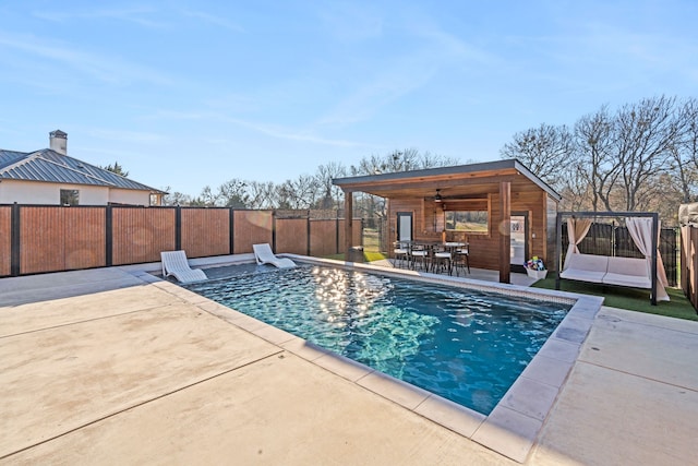 view of swimming pool featuring ceiling fan and a patio