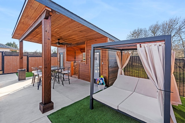 view of patio / terrace with a gazebo, an outdoor structure, and ceiling fan