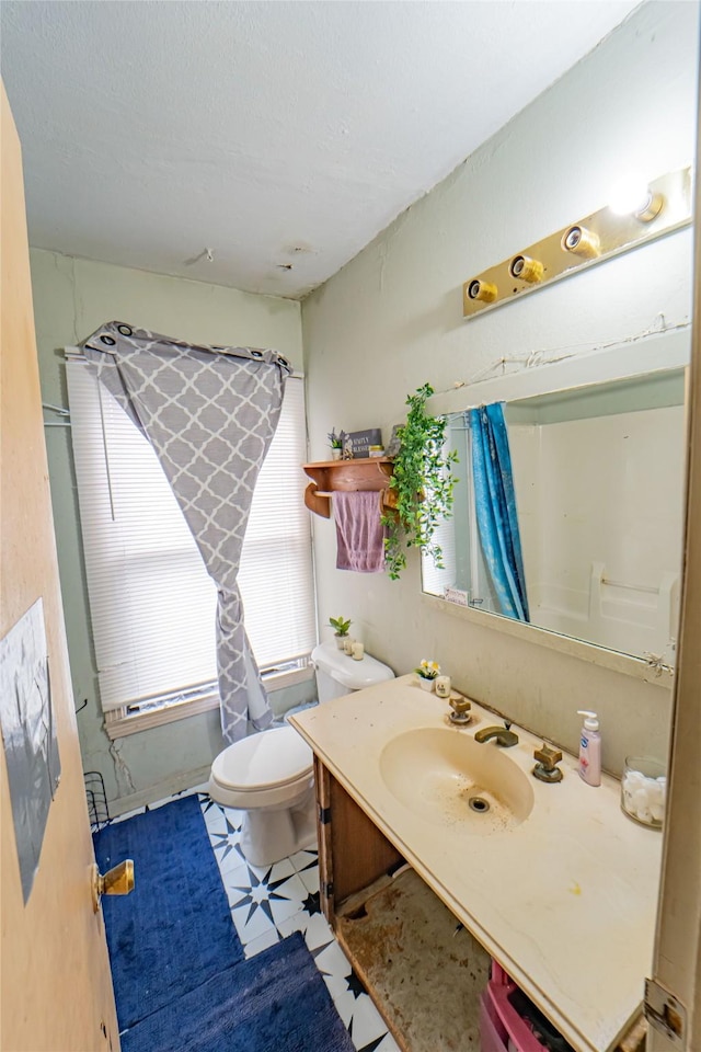 bathroom with vanity, a shower with curtain, and toilet