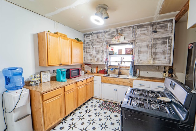 kitchen featuring gas stove and sink