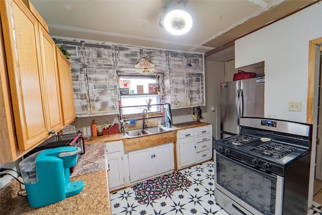 kitchen with white cabinetry, sink, and appliances with stainless steel finishes