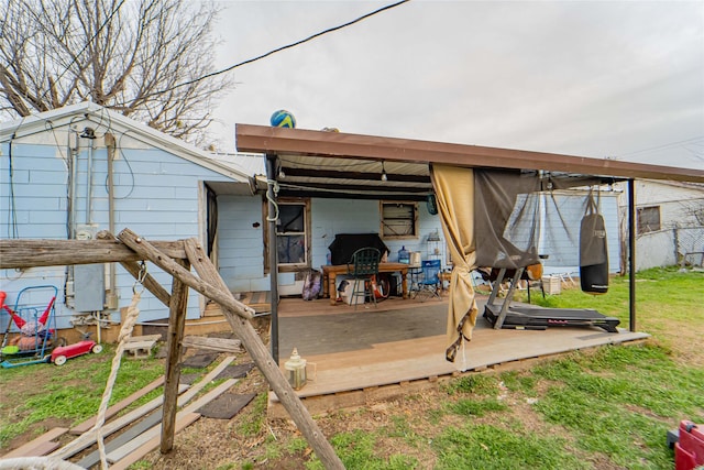 rear view of house with a yard and a deck