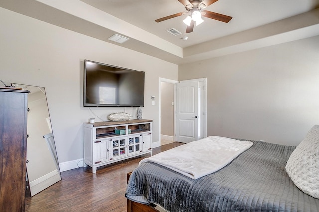 bedroom with visible vents, baseboards, wood finished floors, and a ceiling fan