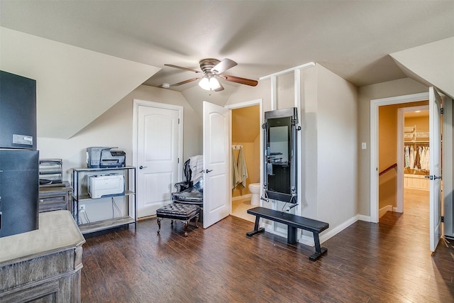 interior space featuring baseboards, a ceiling fan, lofted ceiling, and dark wood-style flooring