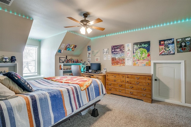 carpeted bedroom featuring visible vents, a ceiling fan, and vaulted ceiling