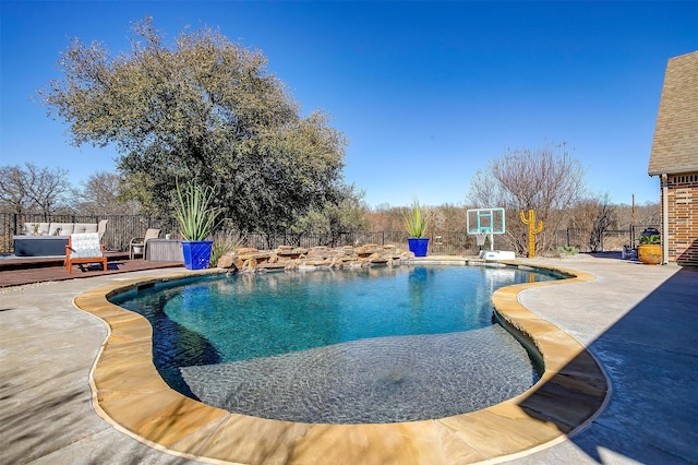 view of pool featuring a patio area, a fenced in pool, a deck, and fence