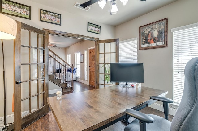 office area with visible vents, baseboards, a ceiling fan, and wood finished floors