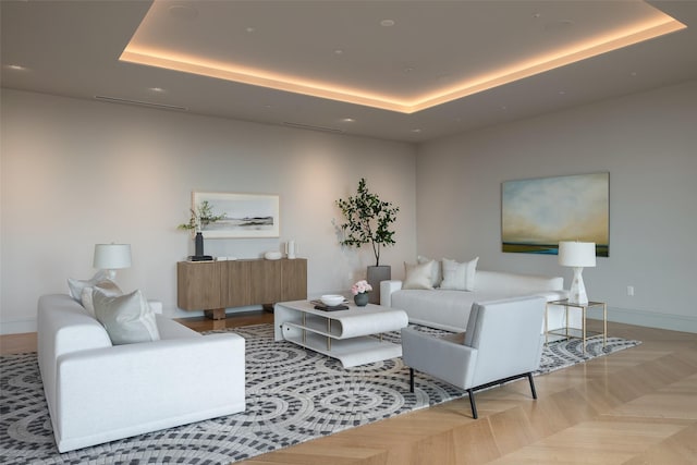 living room with a raised ceiling, baseboards, and recessed lighting