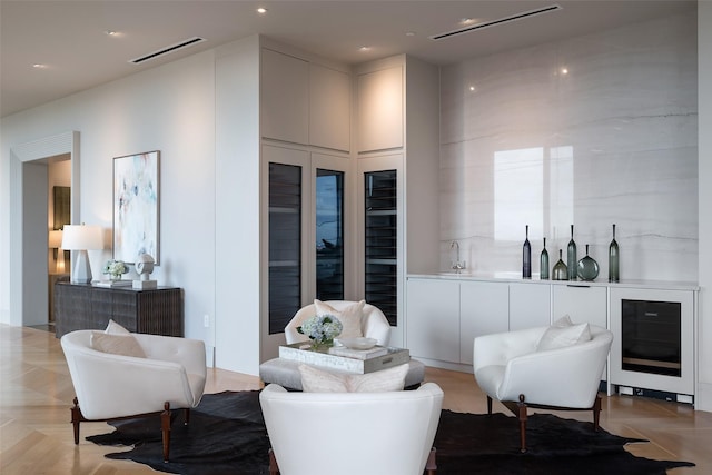 living room with bar area, recessed lighting, and visible vents