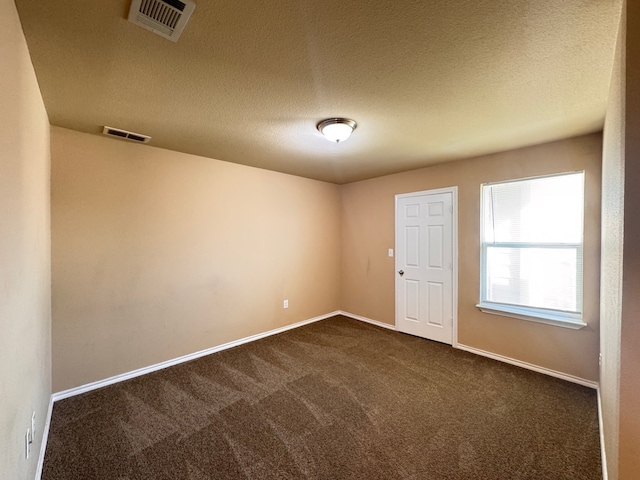 721 Prairie Creek Dr, Princeton, TX 75407 - spare room featuring dark carpet and a textured ceiling
