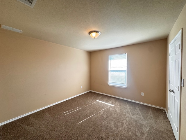 721 Prairie Creek Dr, Princeton, TX 75407 - empty room with a textured ceiling and dark colored carpet