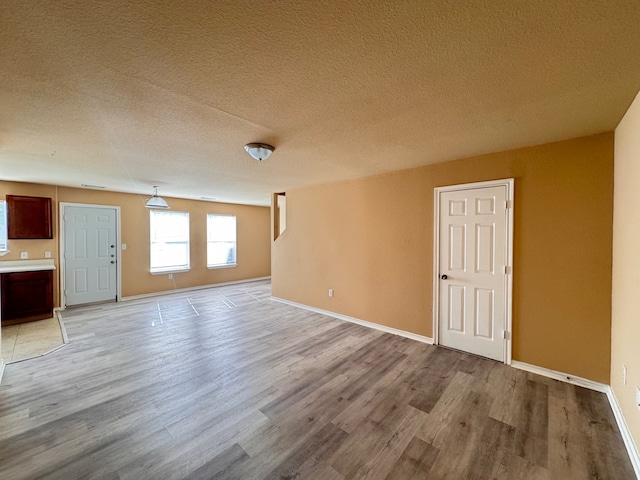 721 Prairie Creek Dr, Princeton, TX 75407 - spare room with light hardwood / wood-style flooring and a textured ceiling