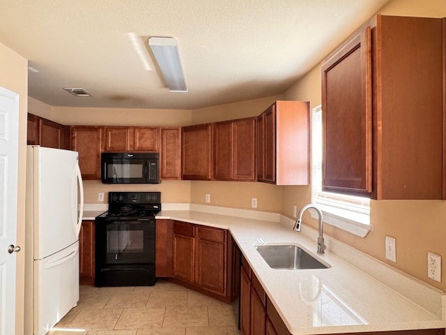 721 Prairie Creek Dr, Princeton, TX 75407 - kitchen featuring sink, light tile patterned floors, a textured ceiling, and black appliances