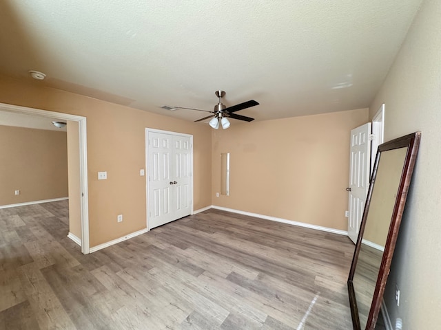 721 Prairie Creek Dr, Princeton, TX 75407 - unfurnished bedroom featuring ceiling fan, a textured ceiling, a closet, and light wood-type flooring