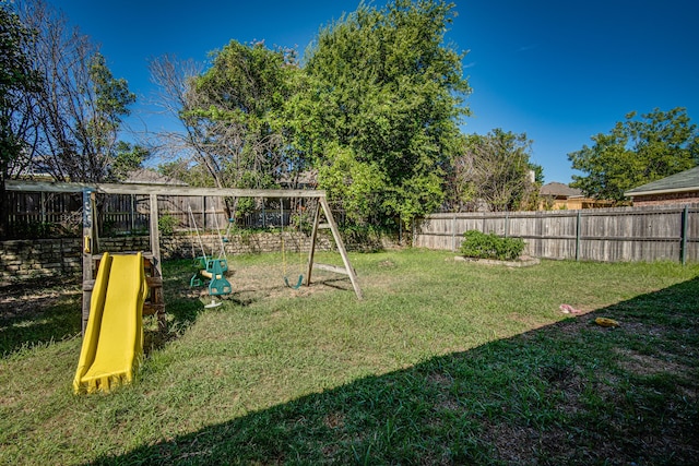 view of jungle gym with a fenced backyard and a lawn