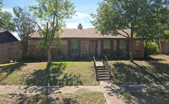 ranch-style home with fence, a front lawn, and brick siding