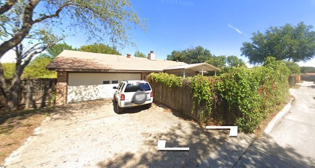 view of property exterior with a garage and fence