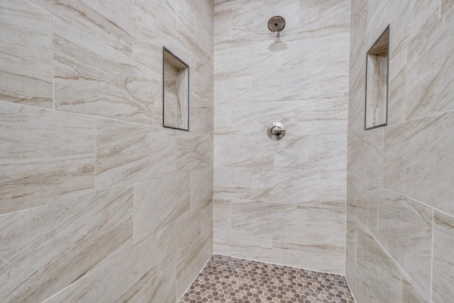 bathroom with tiled shower