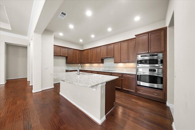 9525 Crestview Dr, Denton, TX 76207 - kitchen with double oven, electric stovetop, dark wood-type flooring, tasteful backsplash, and a kitchen island with sink