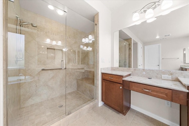 full bath featuring a stall shower, tile patterned flooring, and vanity